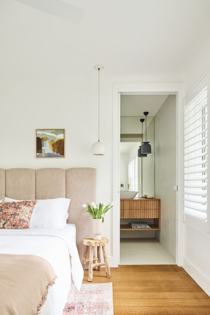 minimal contemporary bedroom with a pink fabric bedhead and pink bedding