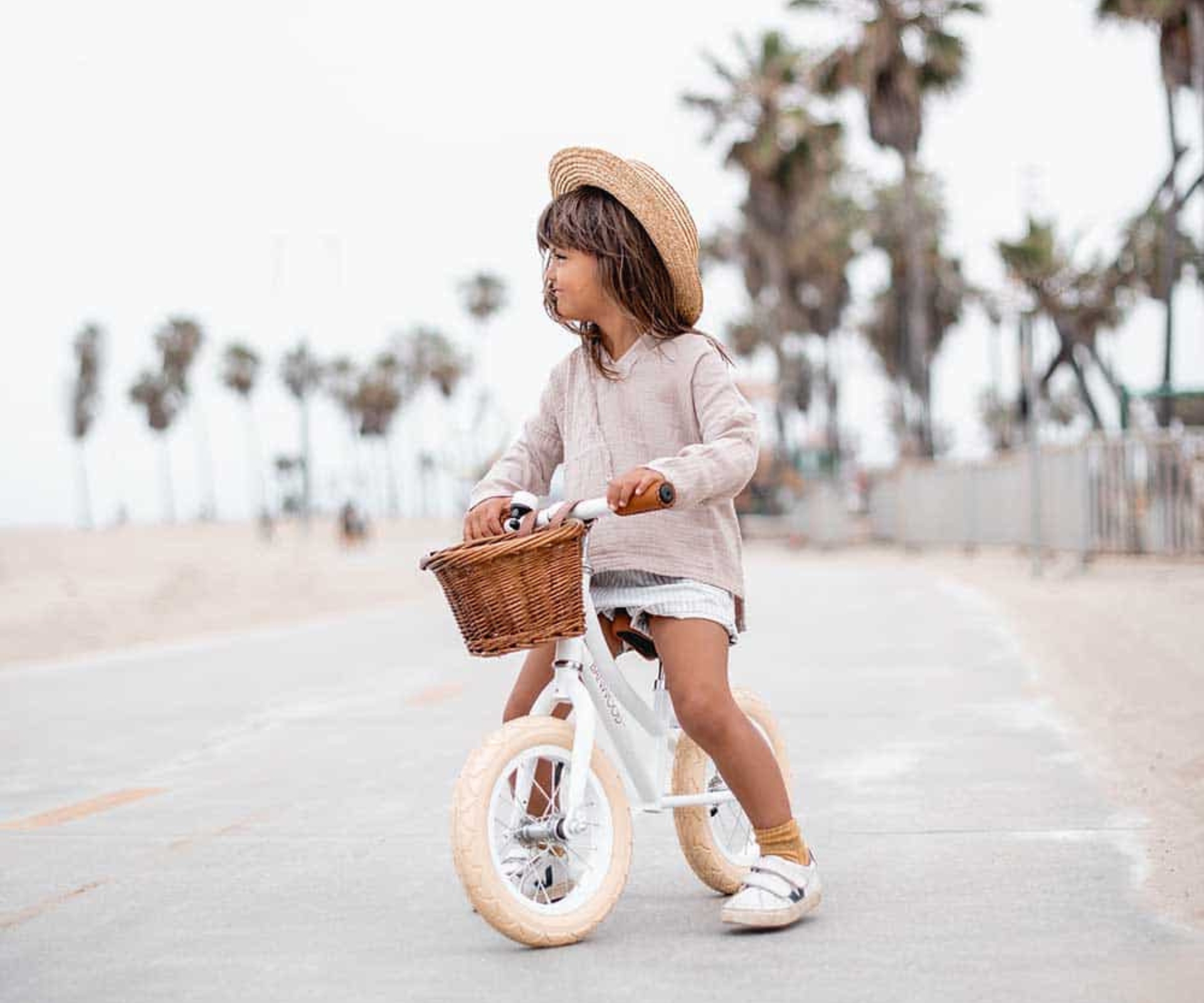 girl riding balance bike outside